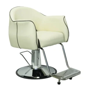 Left side profile of a modern cream salon chair with padded armrests, chrome hydraulic pump, and integrated footrest