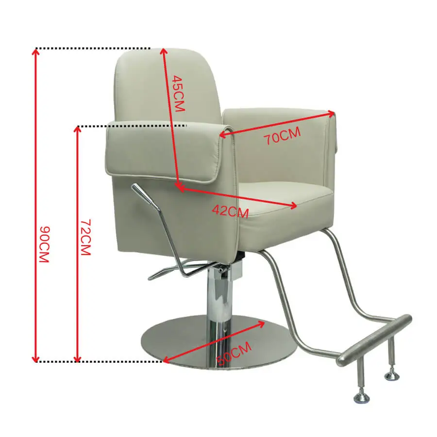 Side angle view of a beige salon styling chair showing thick padded armrests, chrome hydraulic pump, and curved footrest bar