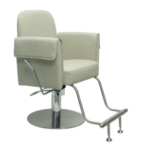 Side angle view of a beige salon styling chair showing thick padded armrests, chrome hydraulic pump, and curved footrest bar
